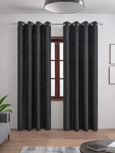Detail of burgundy blackout curtain with damask texture and silver metal grommets