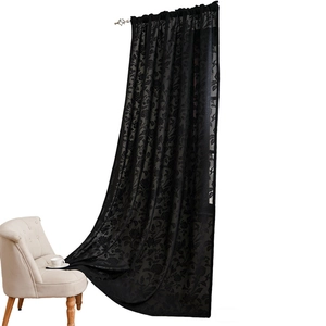 Bohemian black lace curtain with elegant floral patterns in a cozy living room setting
