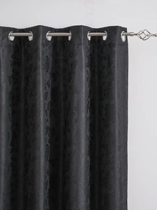 Detail of dark grey damask floral jacquard fabric and silver metal grommets on curtain
