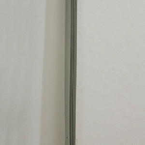 Close-up of flexible grey accordion folding door curtain with dense horizontal texture