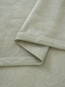 Detailed macro view of French vintage green lace curtain fabric with floral damask pattern