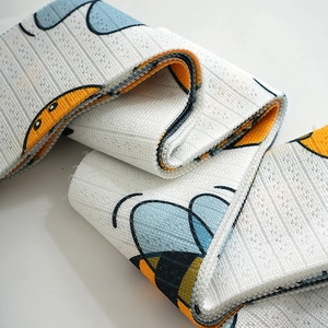 Close-up of knitted fabric texture with cute cartoon bee patterns and stripe weave