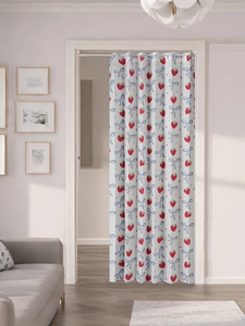 Close-up of strawberry and blue bow print curtain with rings and telescopic rod