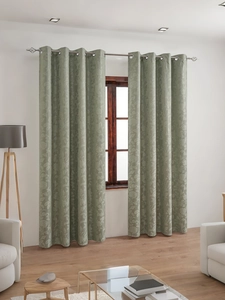 Detail of sage green blackout curtains with floral jacquard pattern and silver eyelets