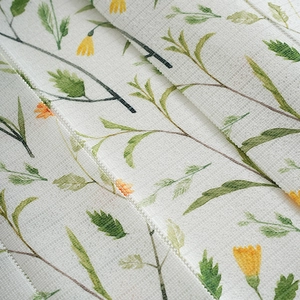 Macro view of printed textile fabric showing clear cross-grain texture and floral pattern