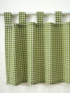 Detail of green gingham tab-top cafe curtain with textured cotton linen fabric