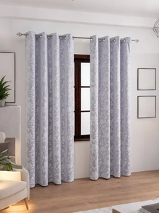 Detail of light purple floral blackout curtains with silver metal grommet rings for windows