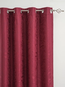 Close-up of burgundy blackout curtains with jacquard floral texture and silver grommets