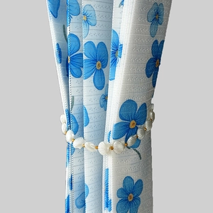 Seashell pearl curtain tieback with gold beads on floral printed folding door curtain