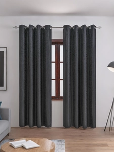 Detail of dark grey grommet blackout curtain with subtle floral jacquard texture for decor