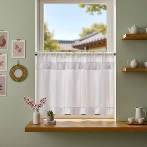 Detail of white cafe curtain featuring vertical stripes and elegant ruffled hem edges