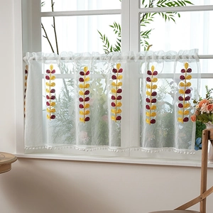 White sheer cafe curtain with leaf embroidery and pom-pom trim for kitchen windows