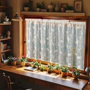 Detail of white semi-transparent lace curtain with bird embroidery and scalloped edges