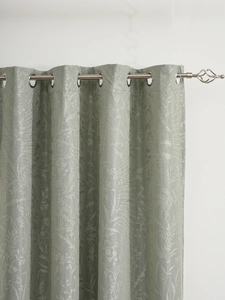Close-up of white blackout curtains with floral jacquard and silver metal grommets