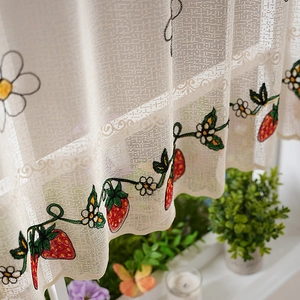 White semi-sheer cafe curtain with strawberry embroidery and lace scallop edge detail