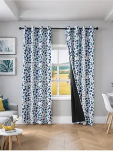 Detail of blackout curtain with colorful polka dots showing silver grommet hanging