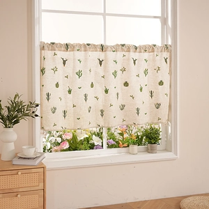 Linen cafe curtain with green cactus embroidery and decorative tassels on beige fabric