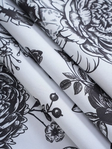Detail shot of black and white floral pattern on premium blackout curtain fabric
