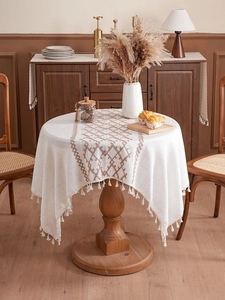 Detailed embroidery on thickened linen tablecloth with elegant white handmade fringe