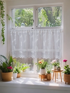 Close-up of white lace cafe curtain with wheat embroidery and elegant scalloped edges