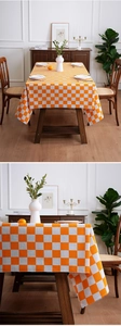 Detail of orange and white checkered tablecloth fabric with premium draped edges