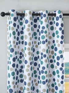 Detail of white blackout curtain with blue and beige polka dots and silver metal grommets