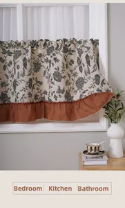 Close-up of vintage floral cafe curtain with terracotta ruffled edge and pleated top