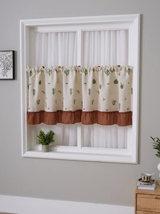 Detail view of the rustic linen cafe curtain showing embroidered cactus and ruffled trim