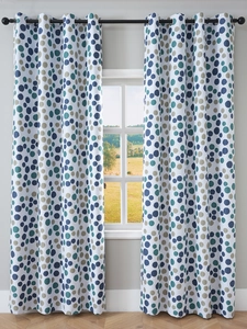 Detail of Nordic blackout curtains with blue and olive polka dots and metal grommets