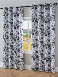 Detail of floral blackout curtains featuring black rose patterns and metal grommet top