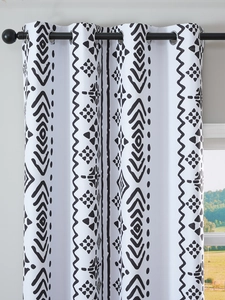 Close-up of black geometric tribal pattern on white blackout curtains with metal grommets