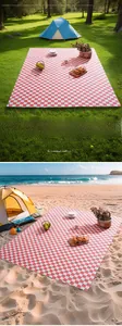 Red and white checkered picnic mat displayed in forest and beach outdoor settings