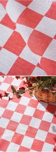 Detailed view of high-density red and white checkered picnic mat with cotton-linen texture
