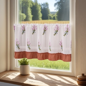 Detail of lavender embroidery and ruffled hem on a rustic white cafe curtain