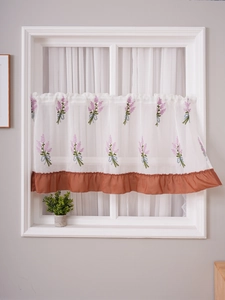 Detail of lavender embroidery on white sheer cafe curtain with orange ruffled trim