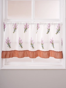 Detail of lavender embroidery on white sheer cafe curtain with pink ruffled edge