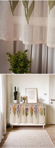 Detail of tulip patterned linen cabinet curtain with elegant texture and light filtering