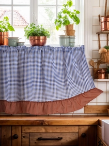 Detail of blue and white gingham kitchen cafe curtain with rustic red ruffle trim