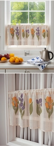 Detail of linen cabinet curtain showing orange tulip prints and fabric texture