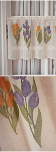 Detail of linen texture and hand-painted tulip patterns on a Japanese style cafe curtain