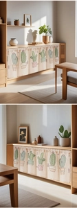Detail of linen cafe curtain with cactus print hanging on a wooden cabinet shelf