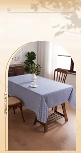 Blue and white checkered tablecloth shown in a cozy home setting with natural leaf shadows