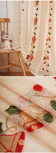 Detail of Christmas bell embroidery on textured linen gauze curtain for festive decor