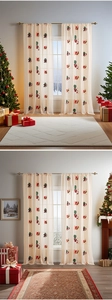 Detailed view of Santa Claus embroidery on festive Christmas sheer curtains for windows
