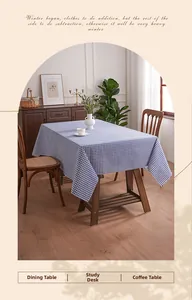 Close-up of blue and white checkered tablecloth with natural raw edges on a wooden table