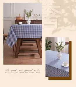 Detailed blue and white checkered tablecloth texture on a dark wooden table surface