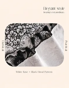 Detail of vintage floral cotton linen tablecloth with black tassel edge and woven texture