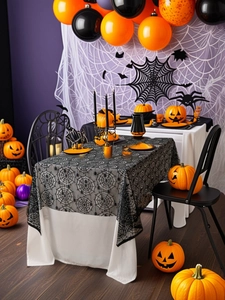 Halloween setting with black spiderweb lace tablecloth on a table with purple background