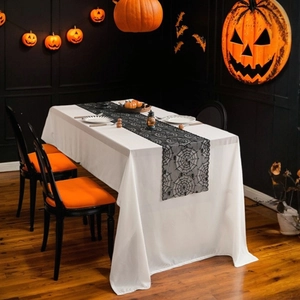 Halloween table runner set with black lace spider web design on white tablecloth