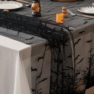 Halloween black lace table runner featuring bat silhouettes and spider web textures